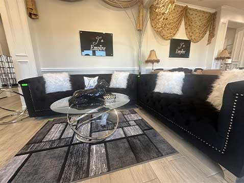 J's Empire's showroom featuring sofas and a coffee table.